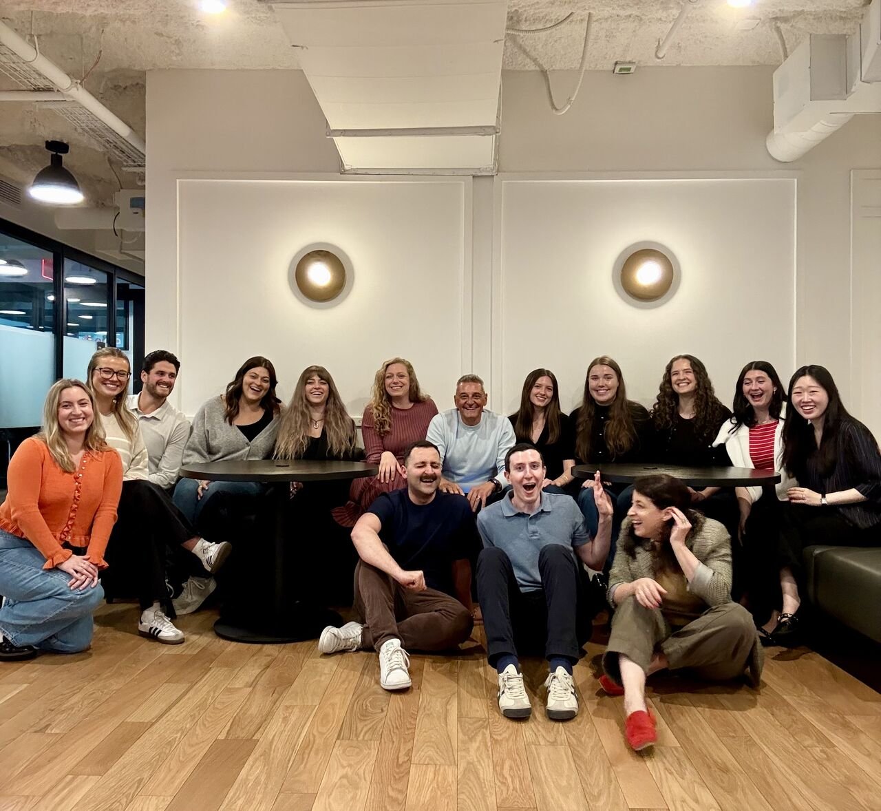 Phil Nardone seated among employees from PAN’s New York City office