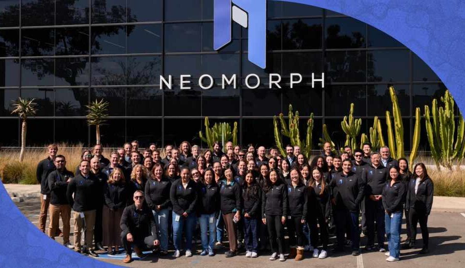 Neomorph colleagues gathered outside a building bearing the company name