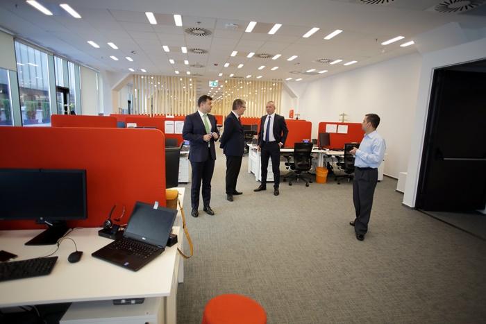 Philip Heasley with colleagues among the desks at ACI’s Timișoara office opening