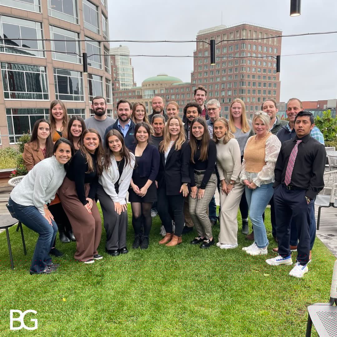 Belfort Group colleagues gathered on a Boston rooftop during an in-person team meeting