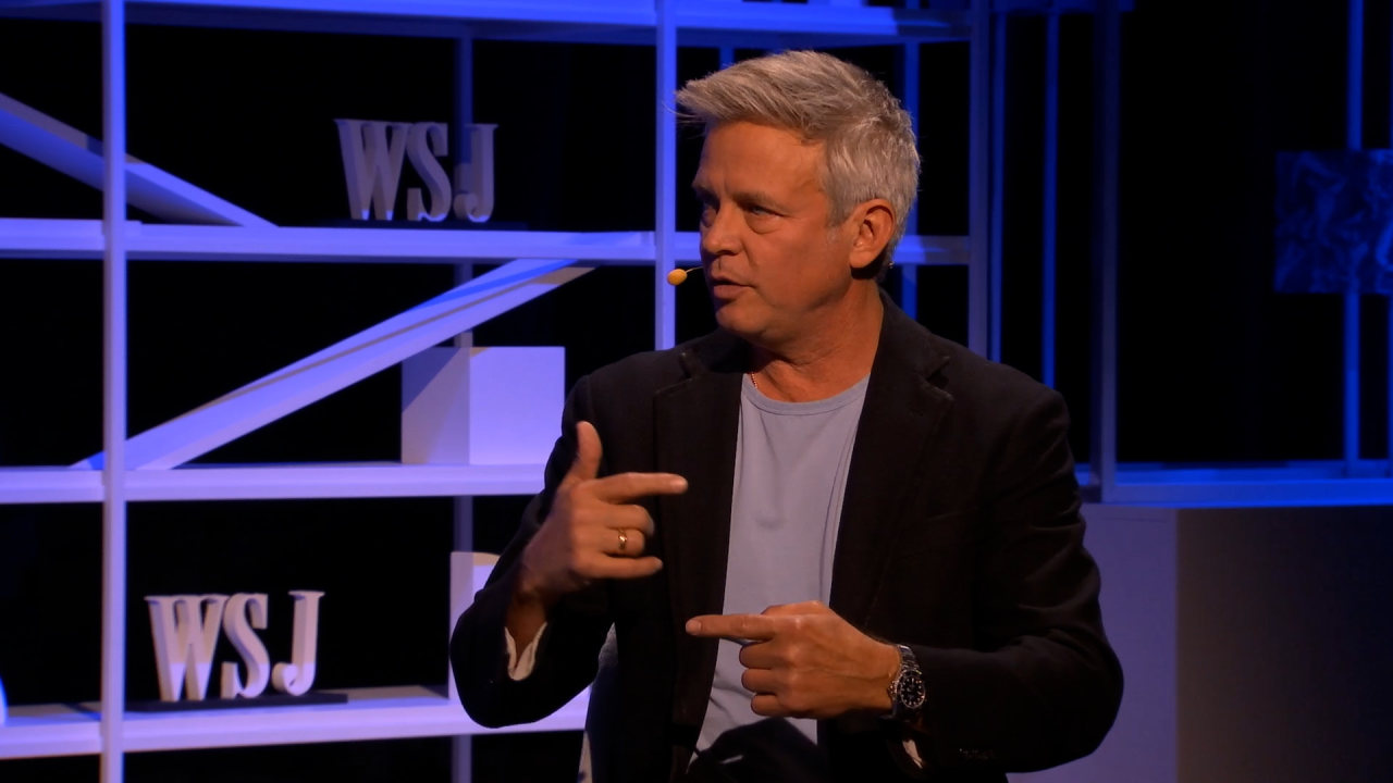 Philip Rosedale gesturing while seated on a Wall Street Journal event stage