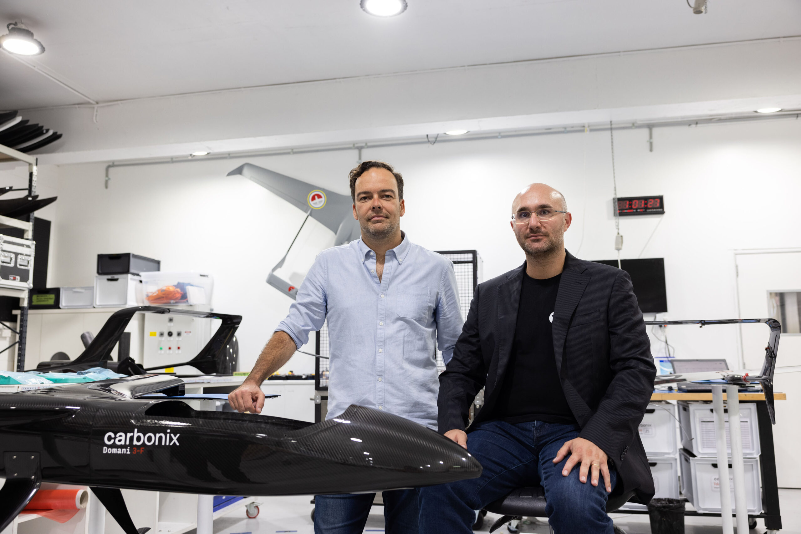Philip van der Burg, left, and Carbonix founder Dario Valenza beside an aircraft in a workshop