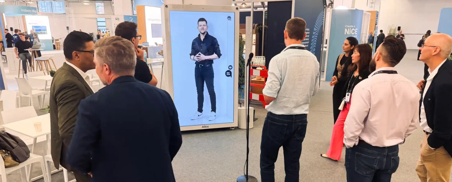 Conference visitors talking to an interactive digital representation of Philipp Heltewig at NiCE World