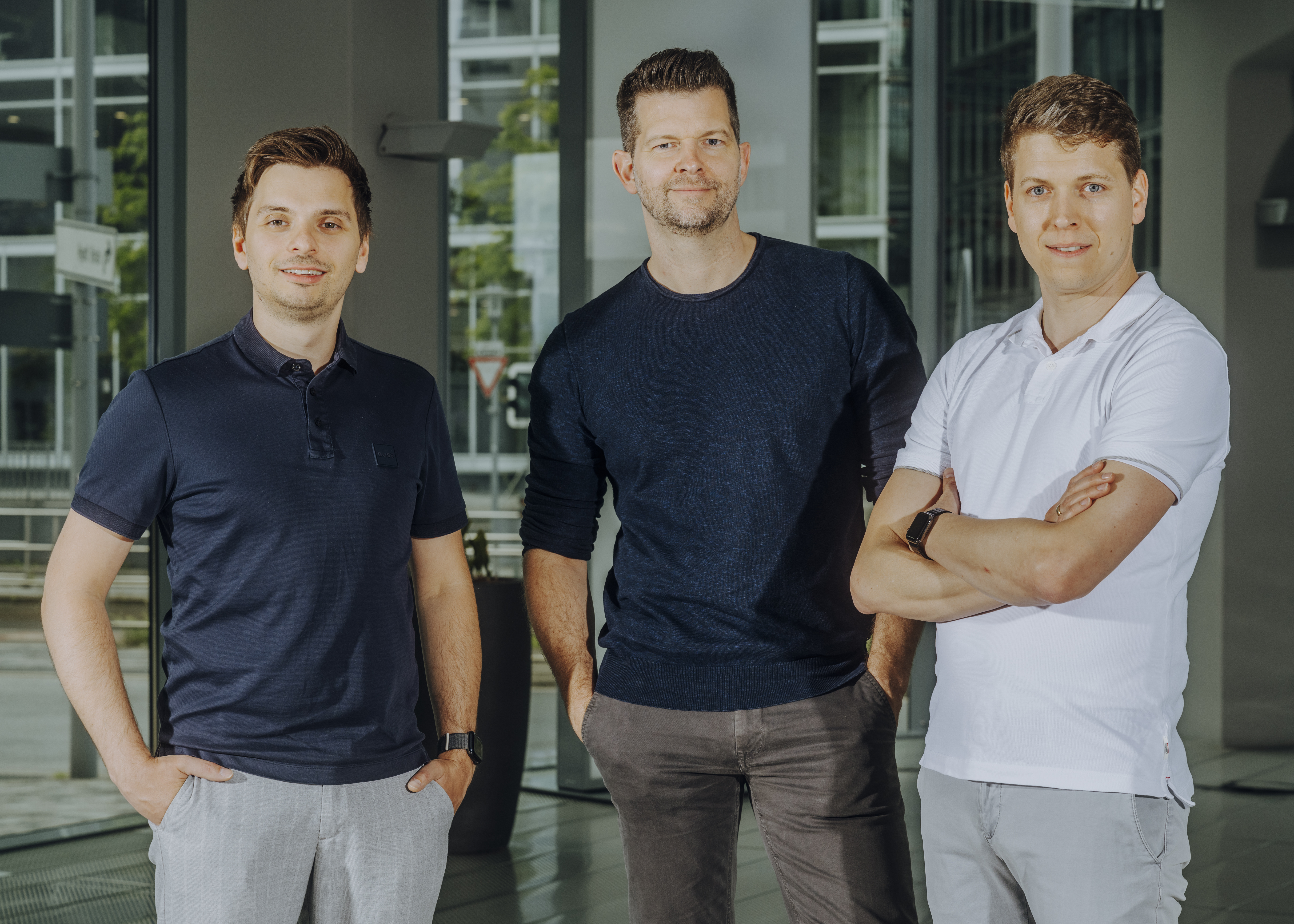 Cognigy co-founders Benjamin Mayr, Philipp Heltewig and Sascha Poggemann standing together