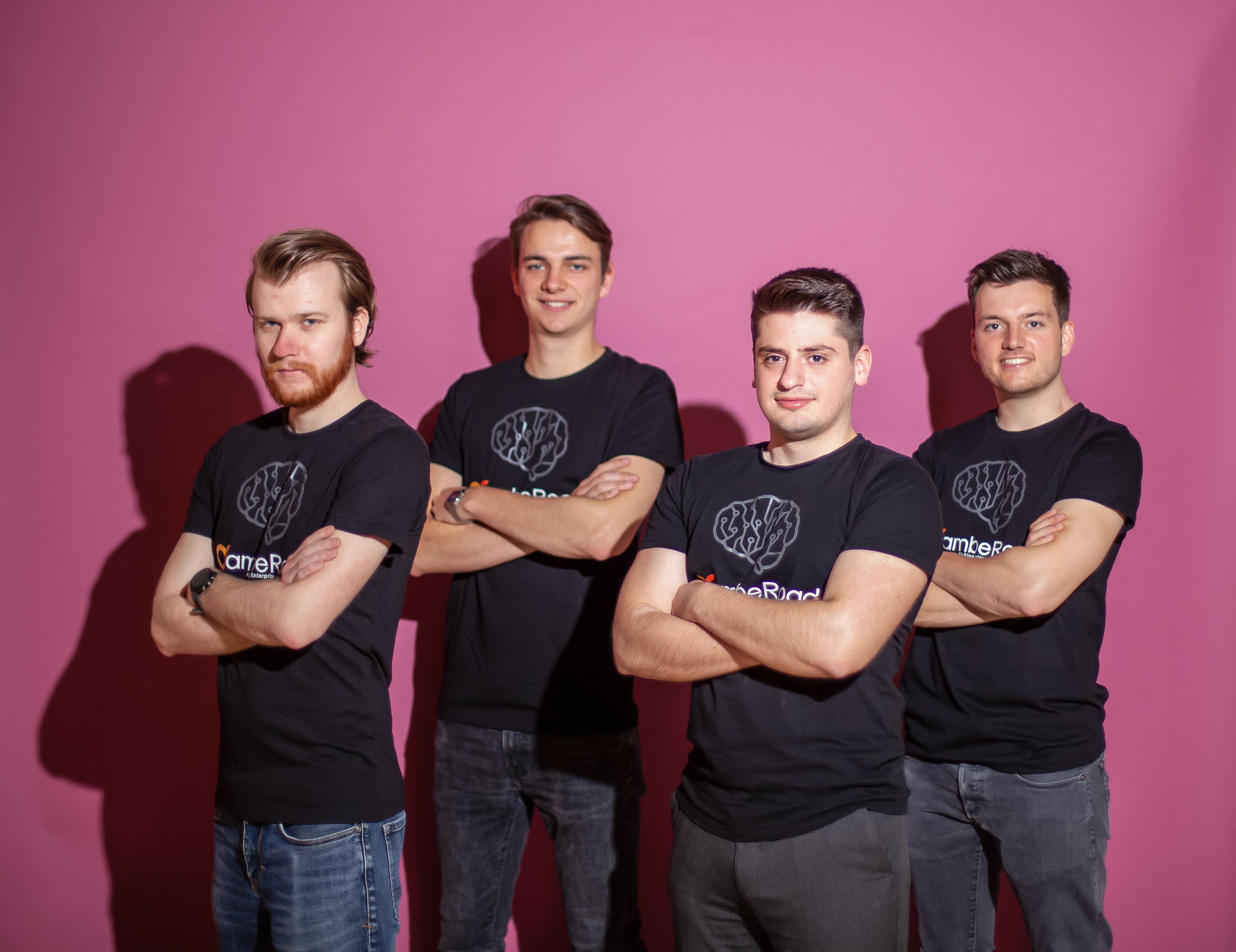 The four early ambeRoad founders standing together in matching black shirts