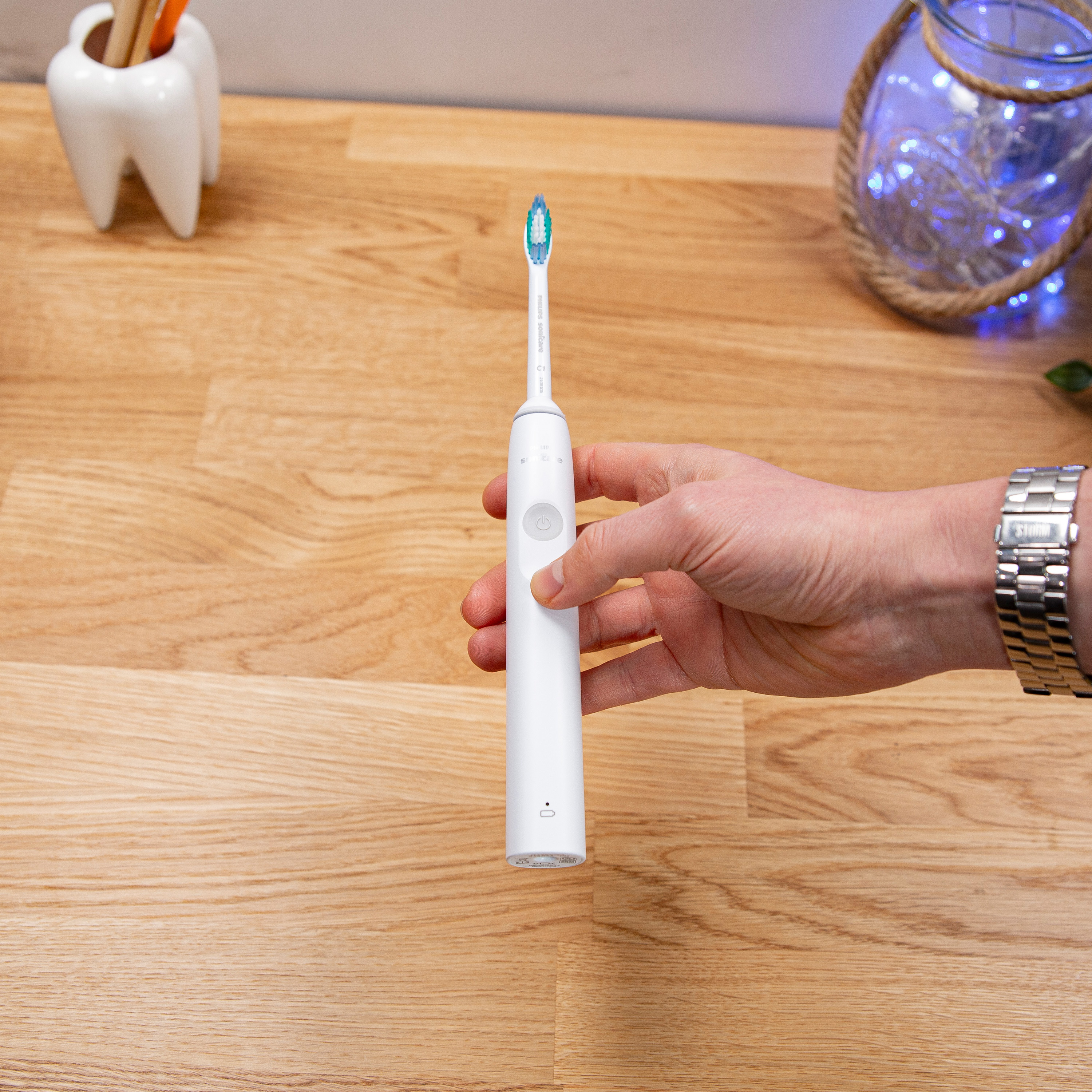 A Philips Sonicare electric toothbrush held over a countertop
