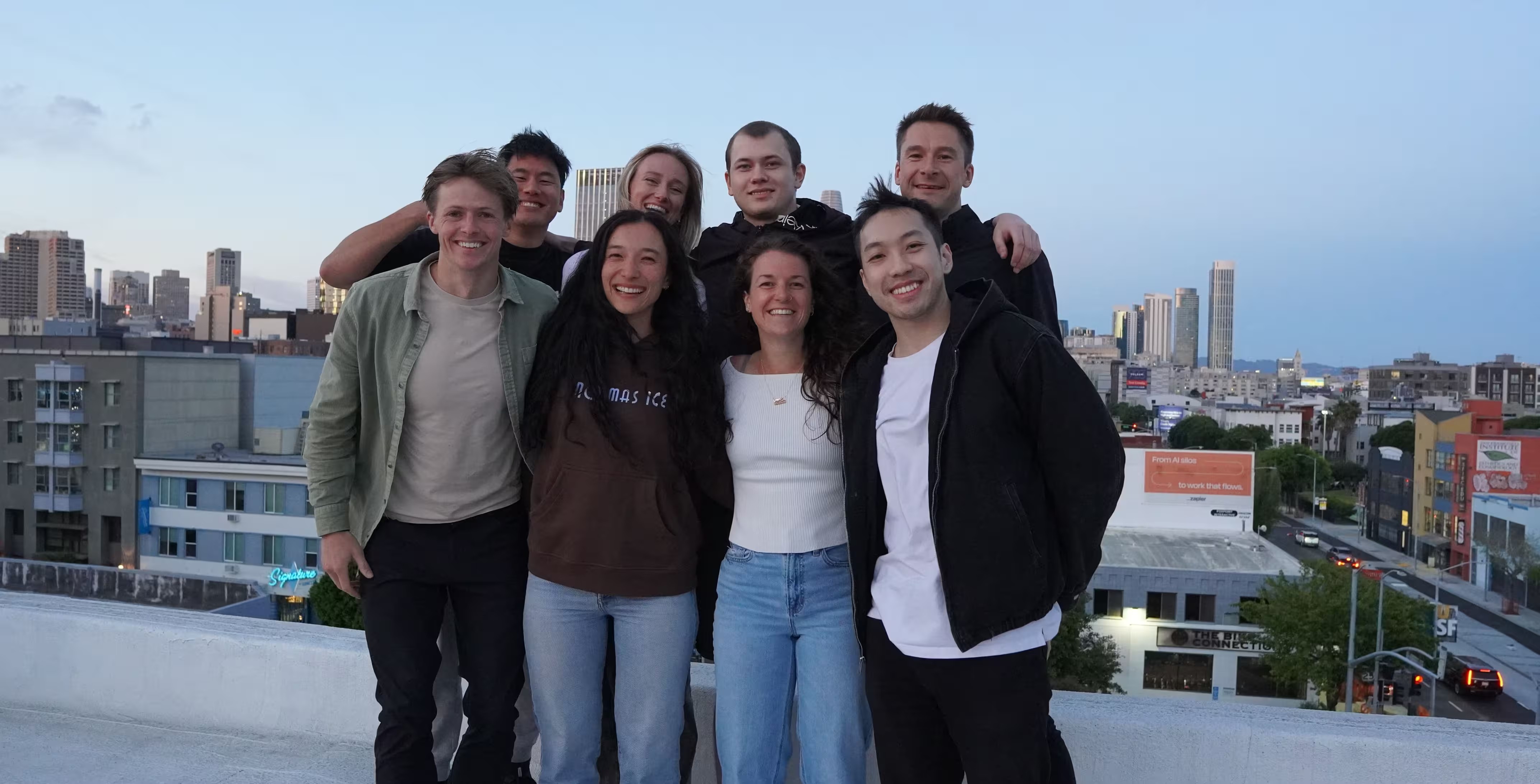 Phonely team members together on a rooftop at dusk