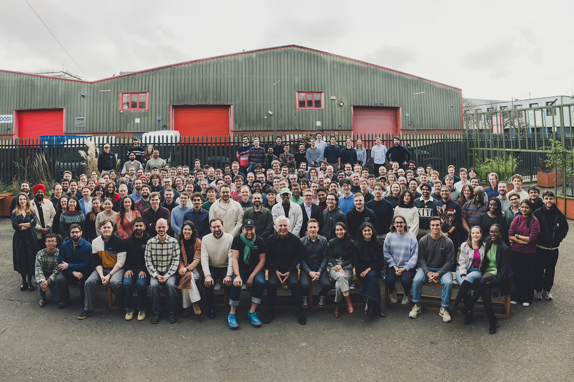 The PhysicsX team gathered outside an industrial building