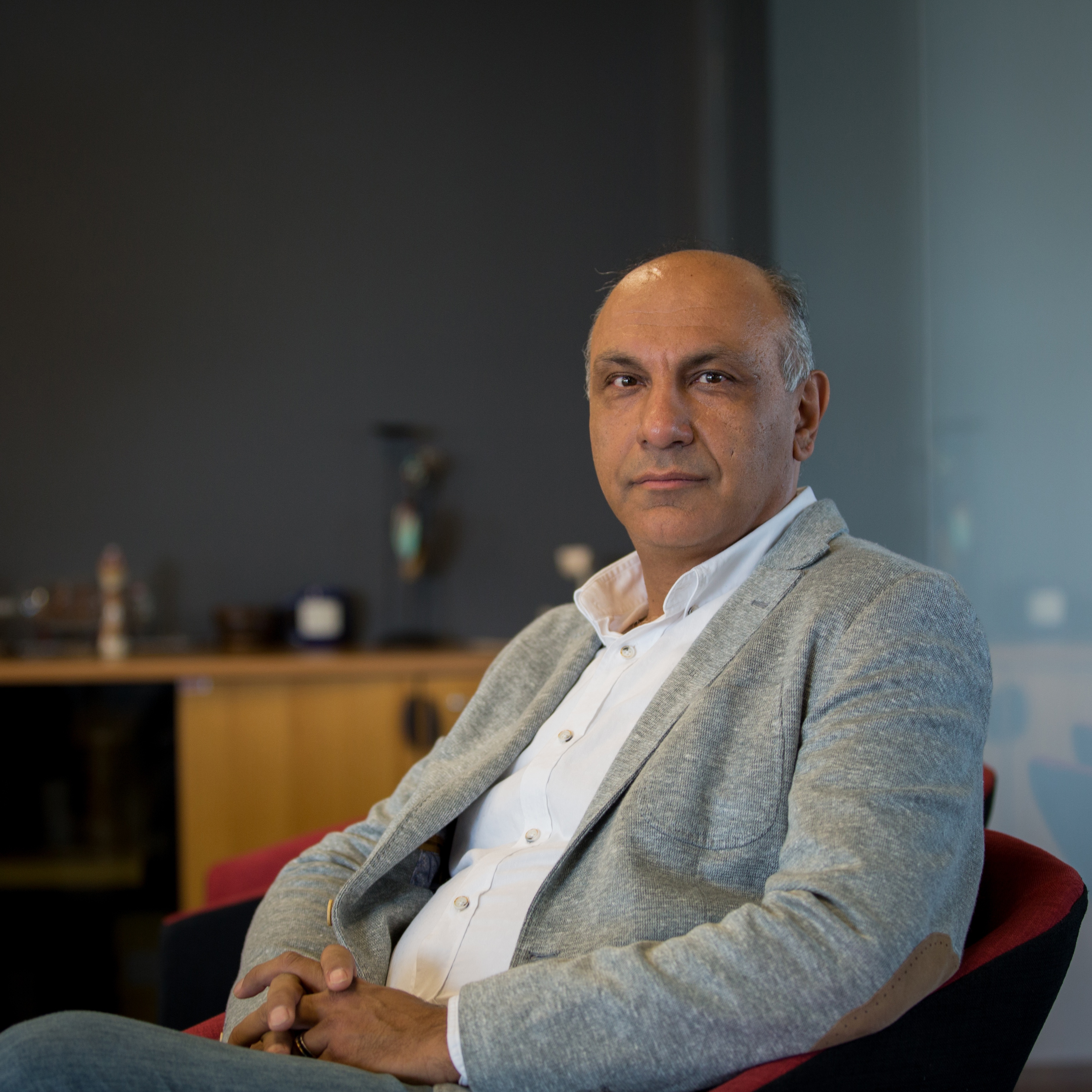 Picsart co-founder and CEO Hovhannes Avoyan seated in a gray jacket