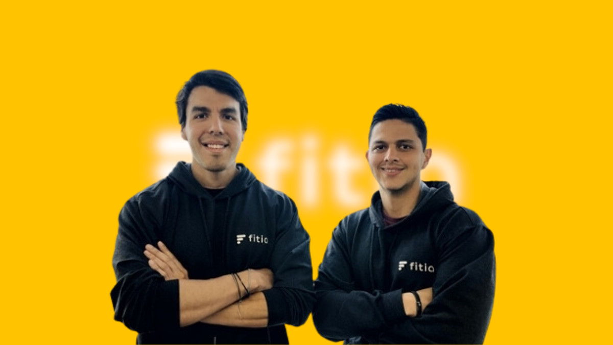 Piero Linares and Ulises Olave wearing Fitia hoodies against a yellow background