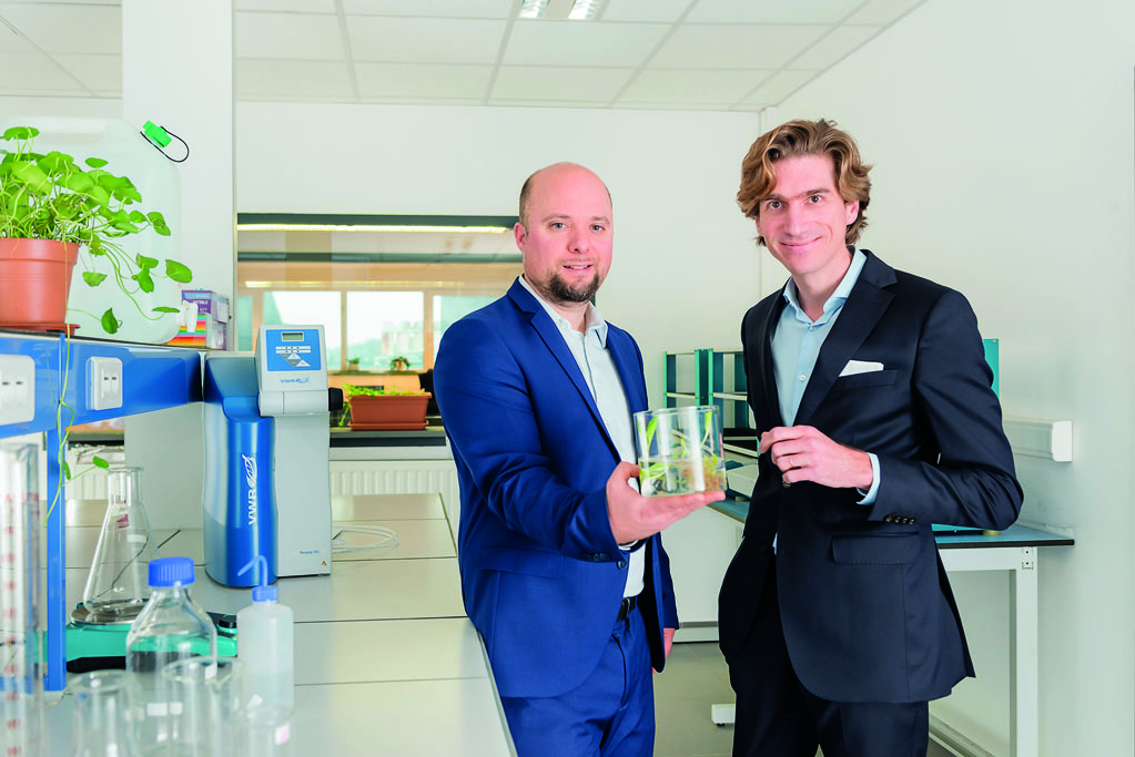 Pierre-Antoine Mariage, left, and Paul-Evence Coppée holding a plant culture in a laboratory
