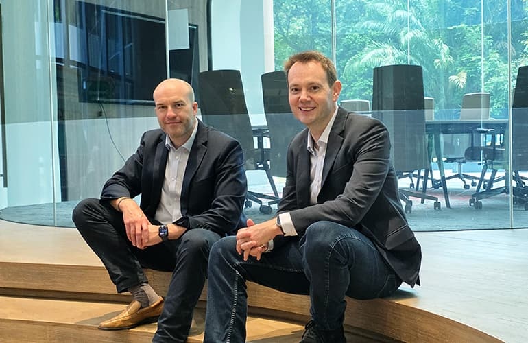 Jerome Boyd-Kirkup, left, and Piers Ingram, right, seated together in a glass-walled office