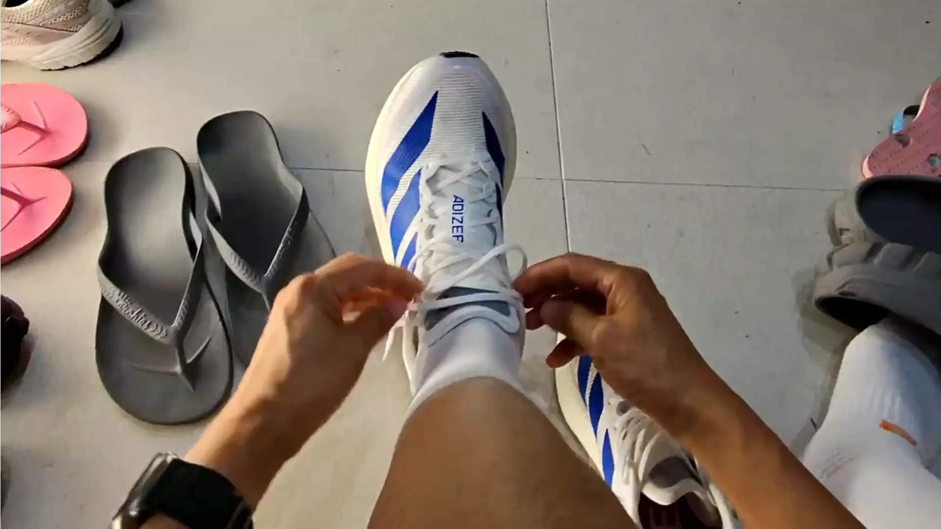 First-person view of a person tying a shoe, from Poseidon's physical AI training-data imagery