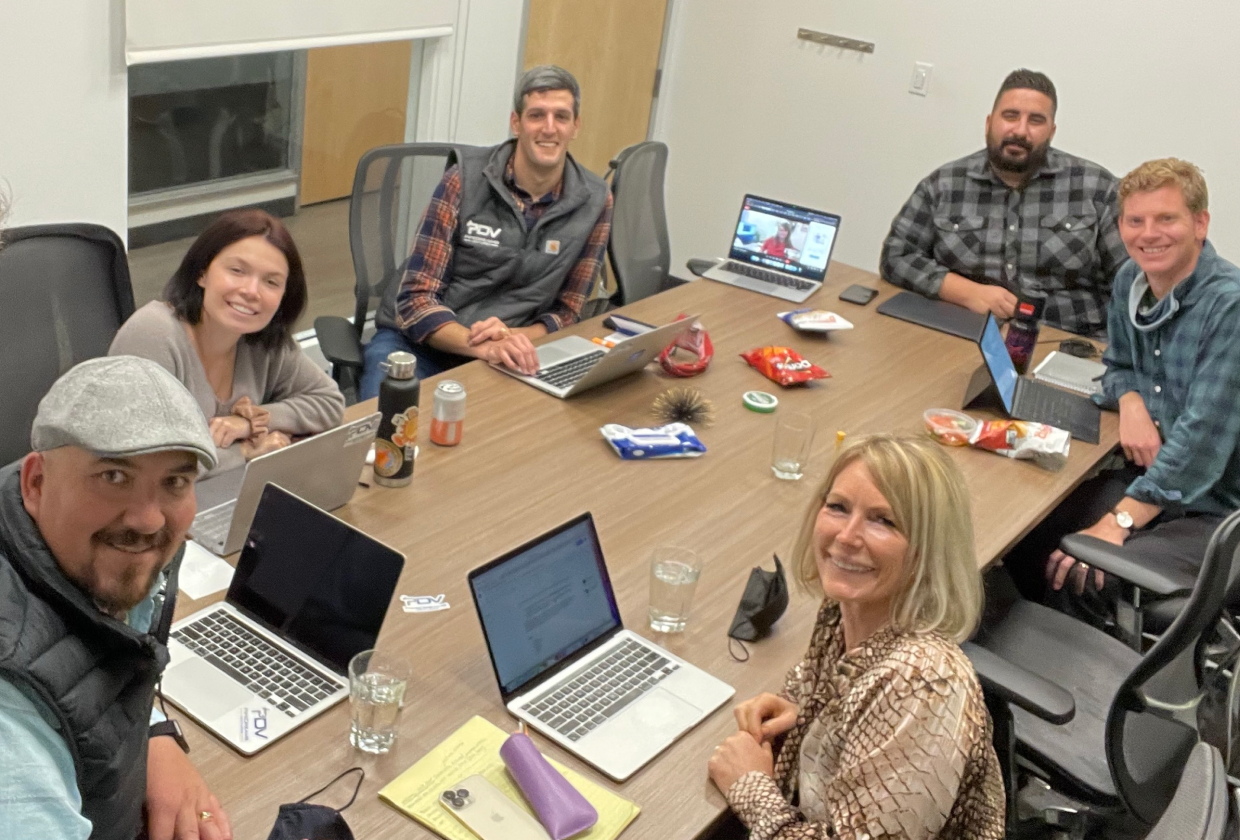 PipeDreams team members gathered around a conference table