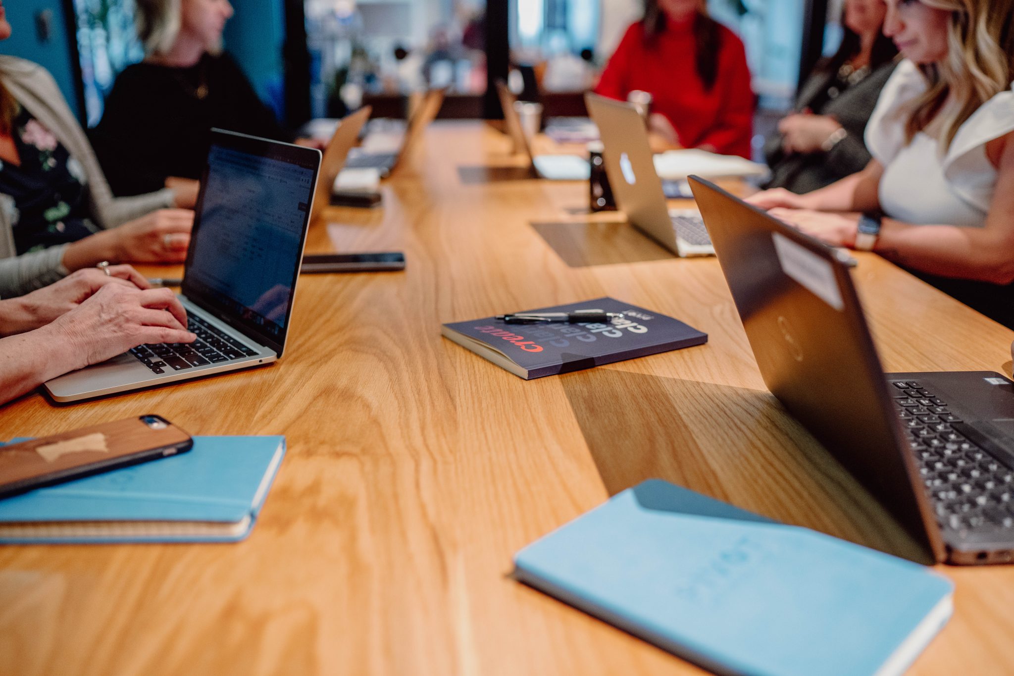 Pivot Strategies team members working around a long wooden table