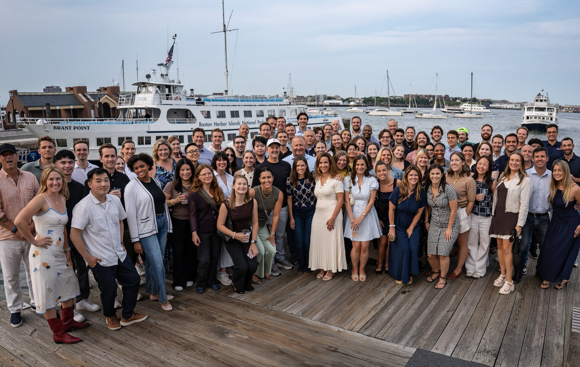A large group of Pixability employees gathered on a Boston Harbor dock