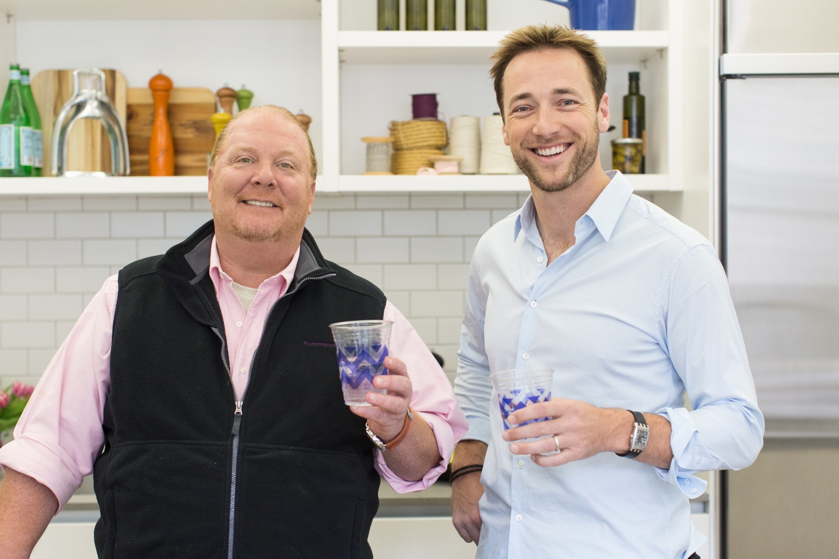 PJ Brice, at right, and Mario Batali holding patterned Cheeky cups in a kitchen