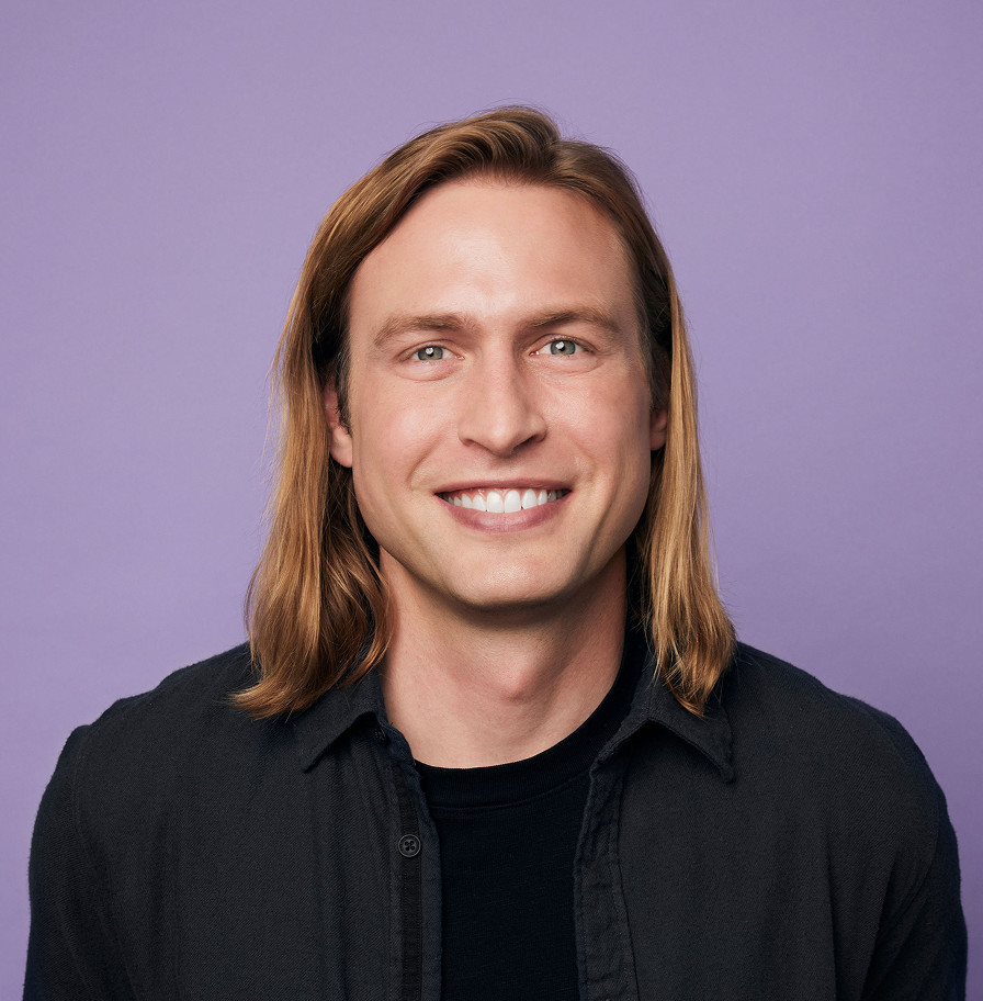 Plaid co-founder and CEO Zach Perret against a pale purple background