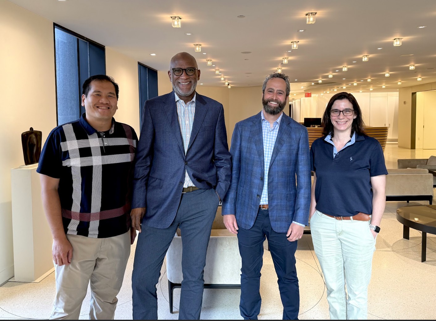 Four members of the PlanScout team standing together during a company offsite