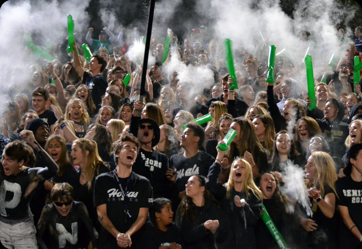 Students cheering together in a high school sports student section
