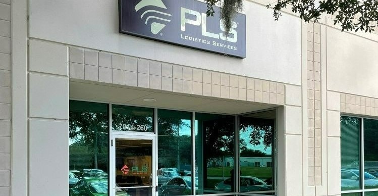 Entrance to a PLS Logistics office, with company signage above glass doors