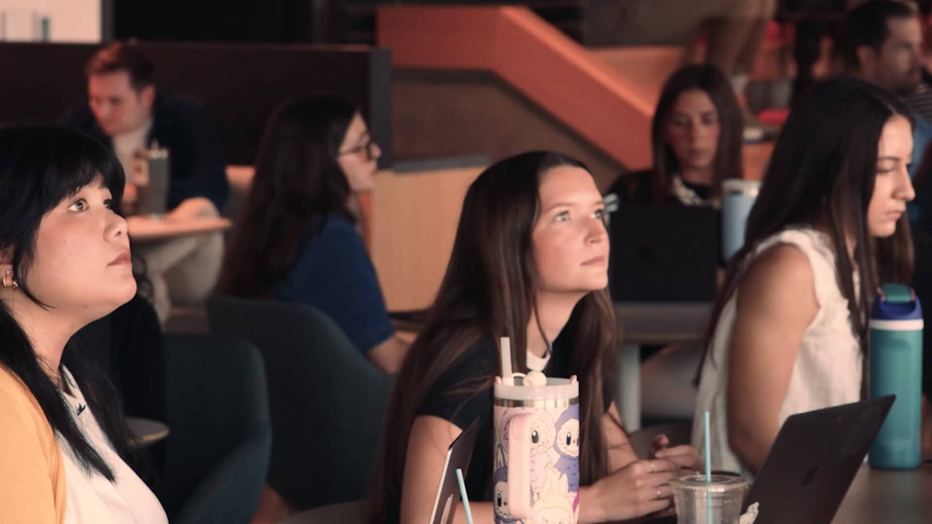 PMG team members watching a presentation in the Dallas office