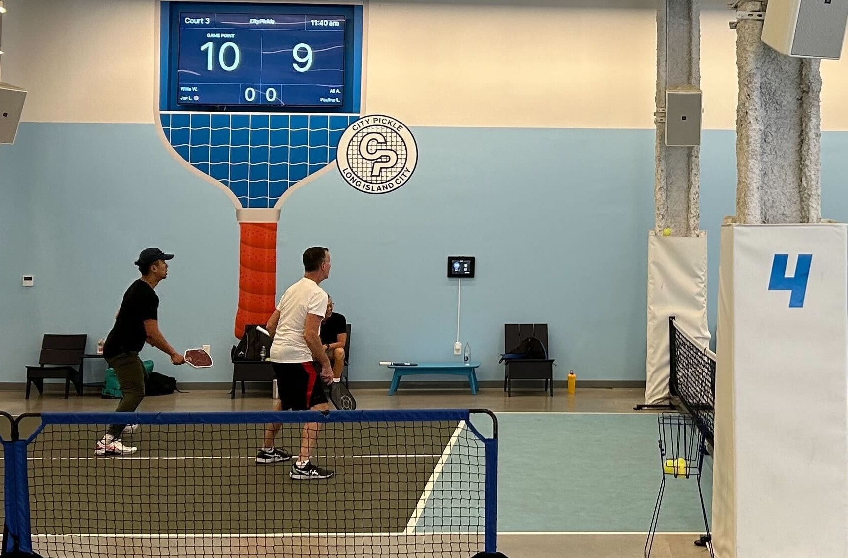 PodPlay digital scoreboard monitors installed above playing courts