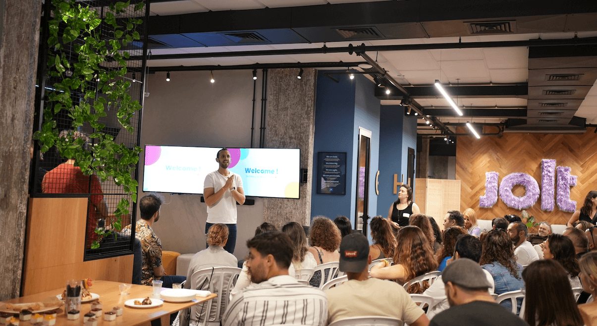 An audience gathered at a Jolt alumni community event