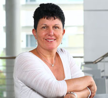 Pola Zucker seated in an office in a press portrait