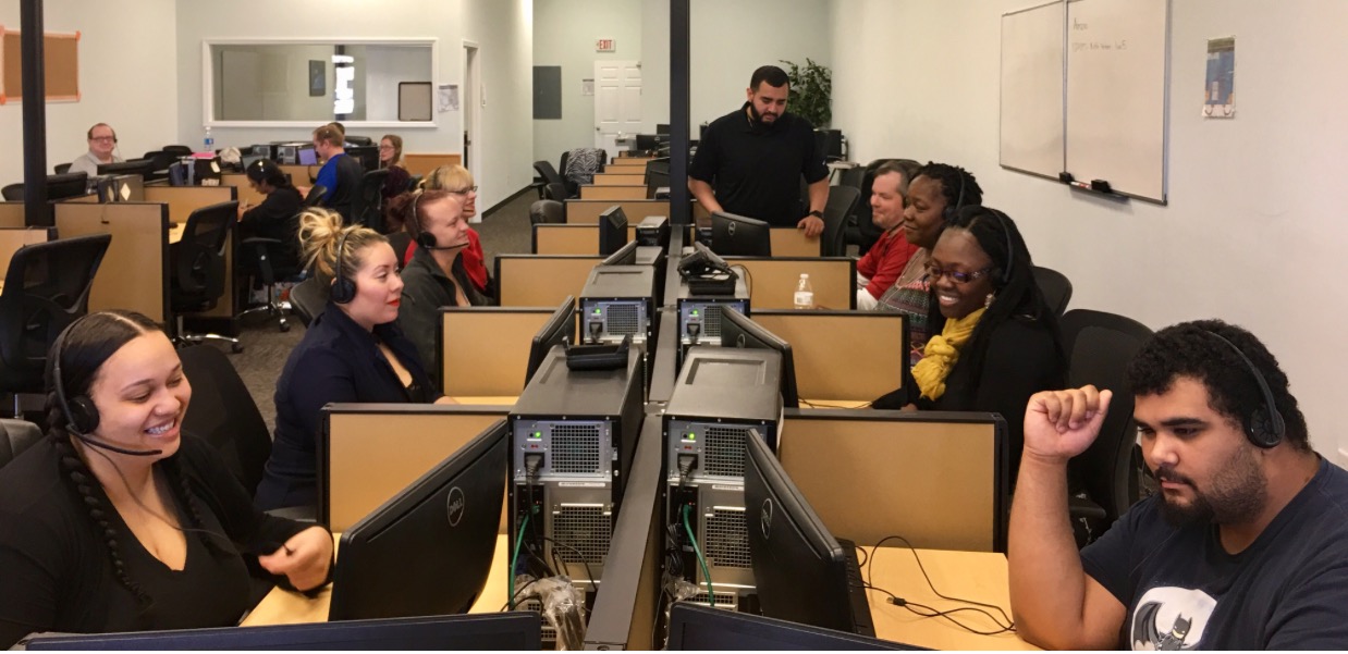 Political Connection telephone agents working at rows of call-center stations