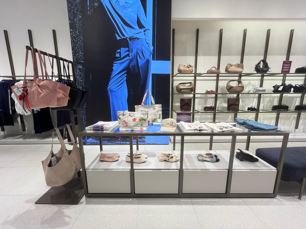 Pomelo retail display with handbags, shoes, hats and folded clothing