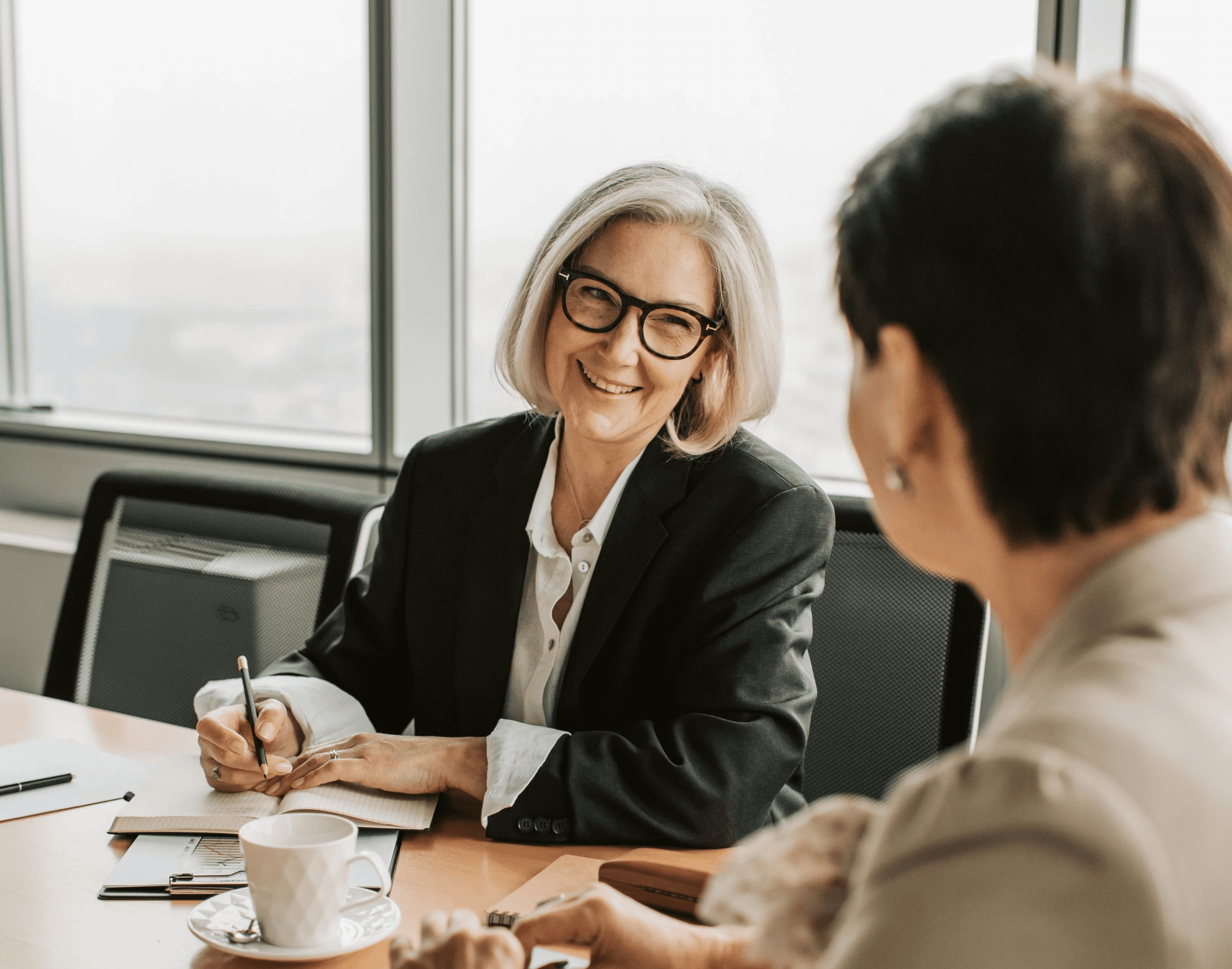 An advisor and a retirement saver talking across a table