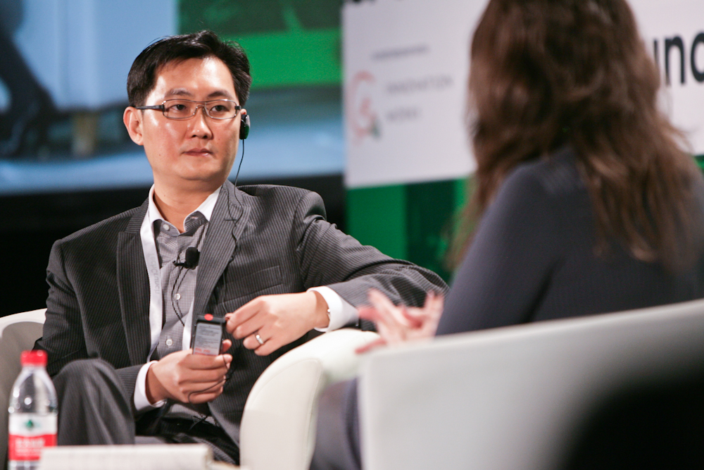Pony Ma seated opposite Sarah Lacy during an onstage interview at Disrupt Beijing in 2011