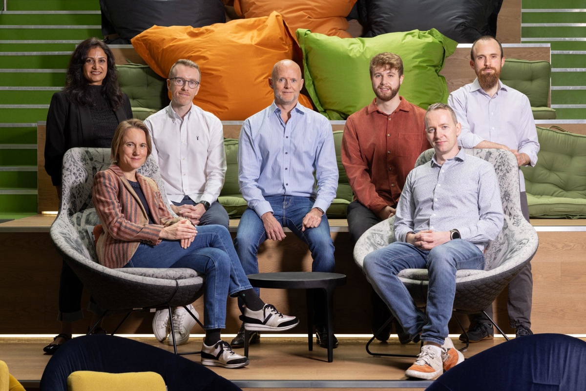 Seven members of PortSwigger's leadership team seated in a colorful office