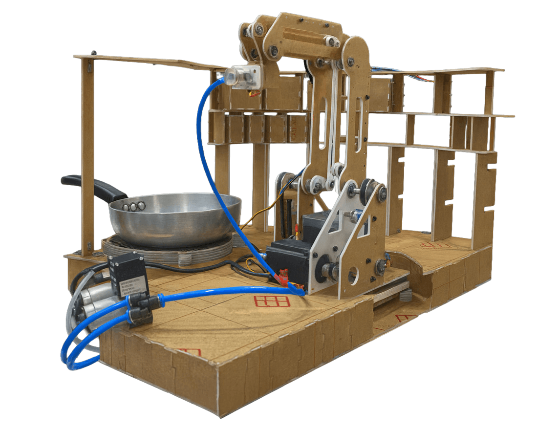 Posha's first open robotic arm prototype beside a cooking pan