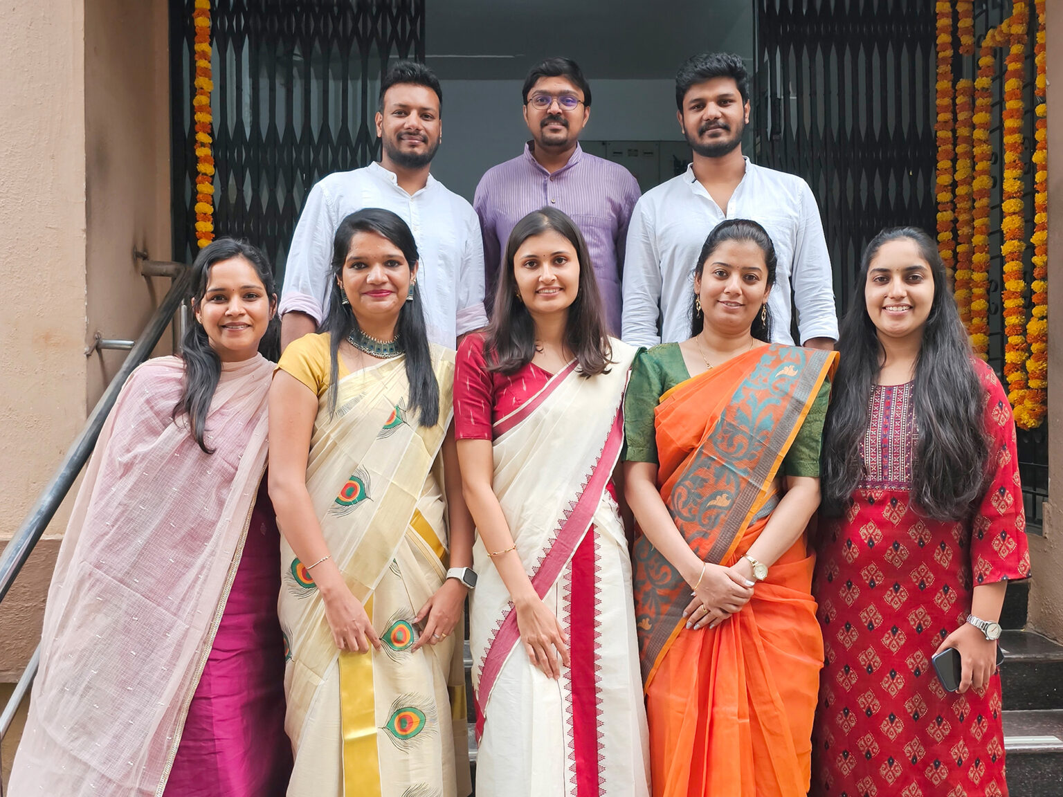 Members of Position²’s creative team posing together in their office
