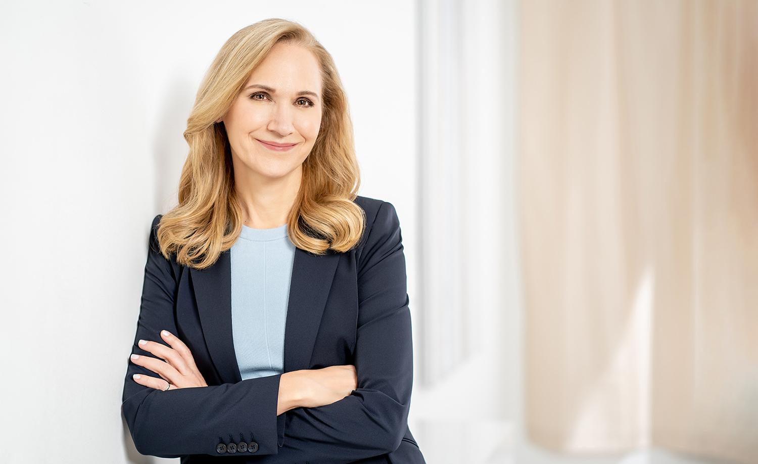 April Dunford standing with her arms folded in a light-filled room