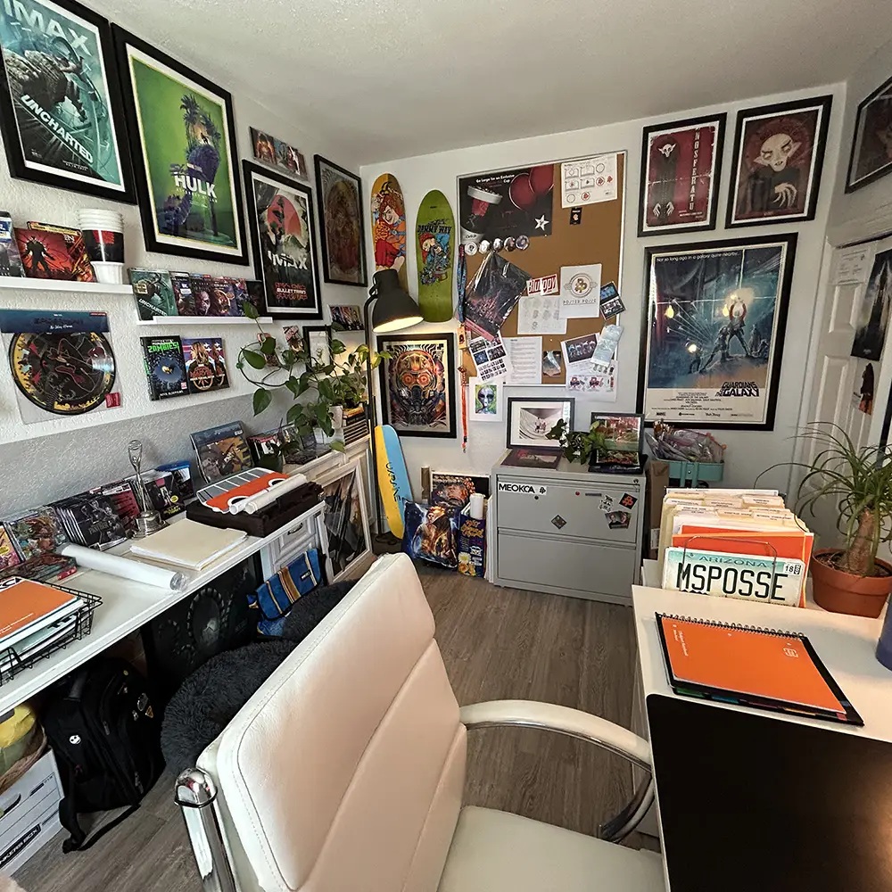 Poster Posse office filled with framed film art, physical media, records and skateboards
