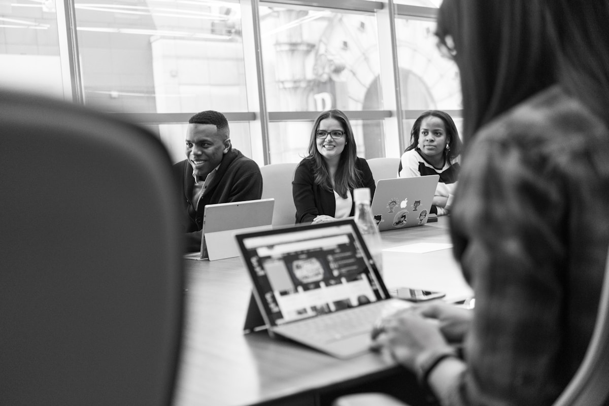 Colleagues reviewing work together around a conference table