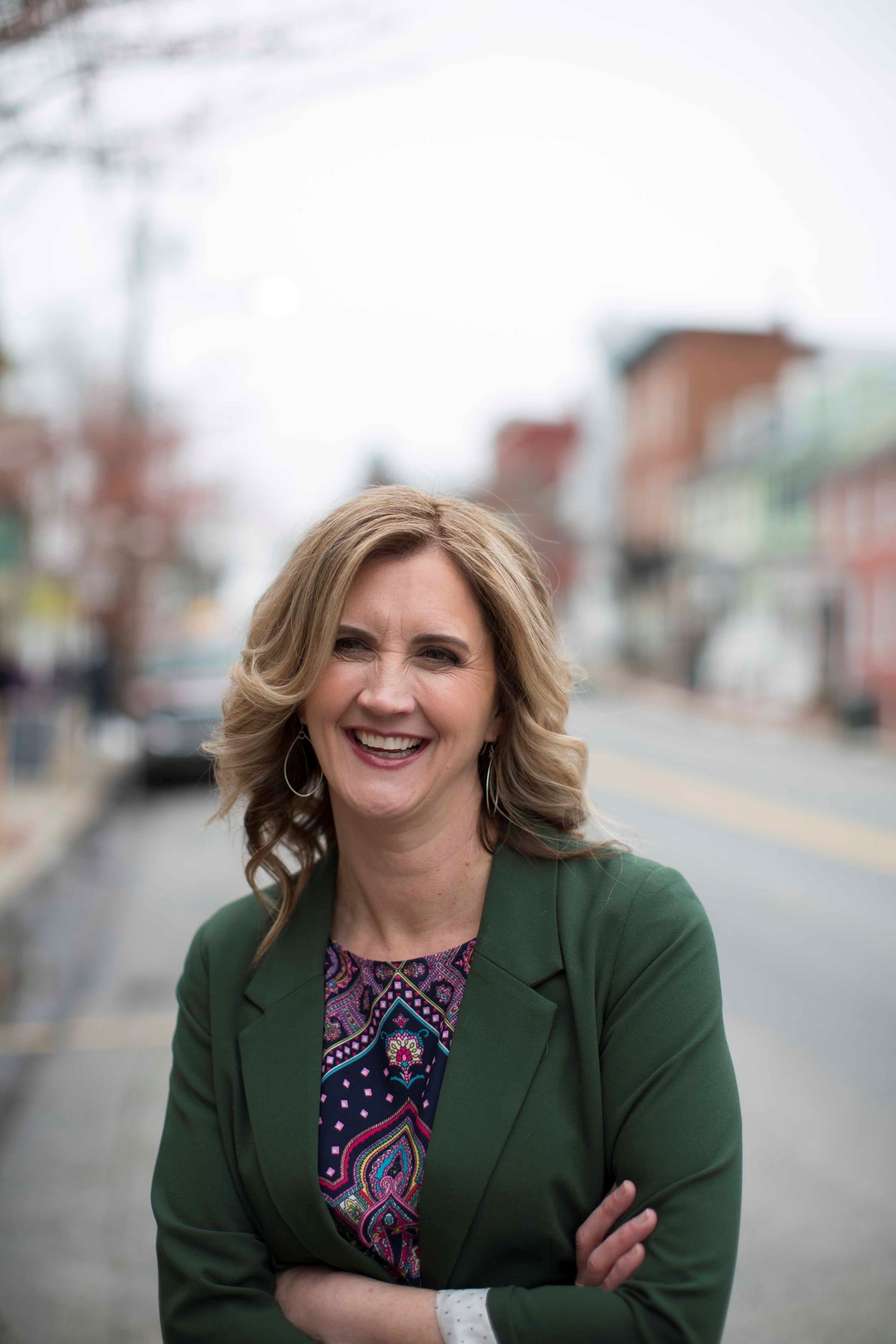 PPR Strategies founder Sandy Dubay smiling on a downtown Frederick street