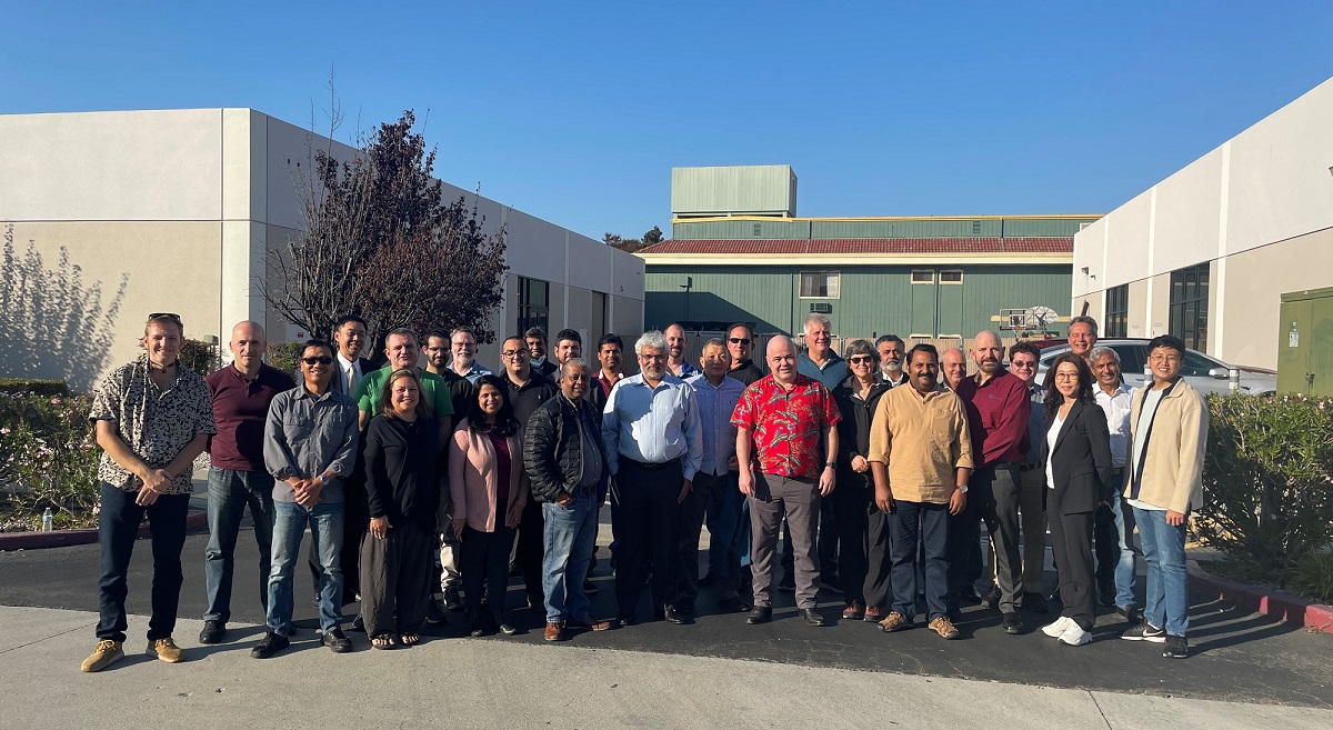 Prakash Narain, near the center in a light blue shirt, with the Real Intent team outdoors in 2022.