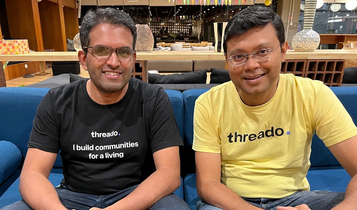 Threado co-founders Abhishek Nalin, left, and Pramod Rao, right, seated together in Threado T-shirts
