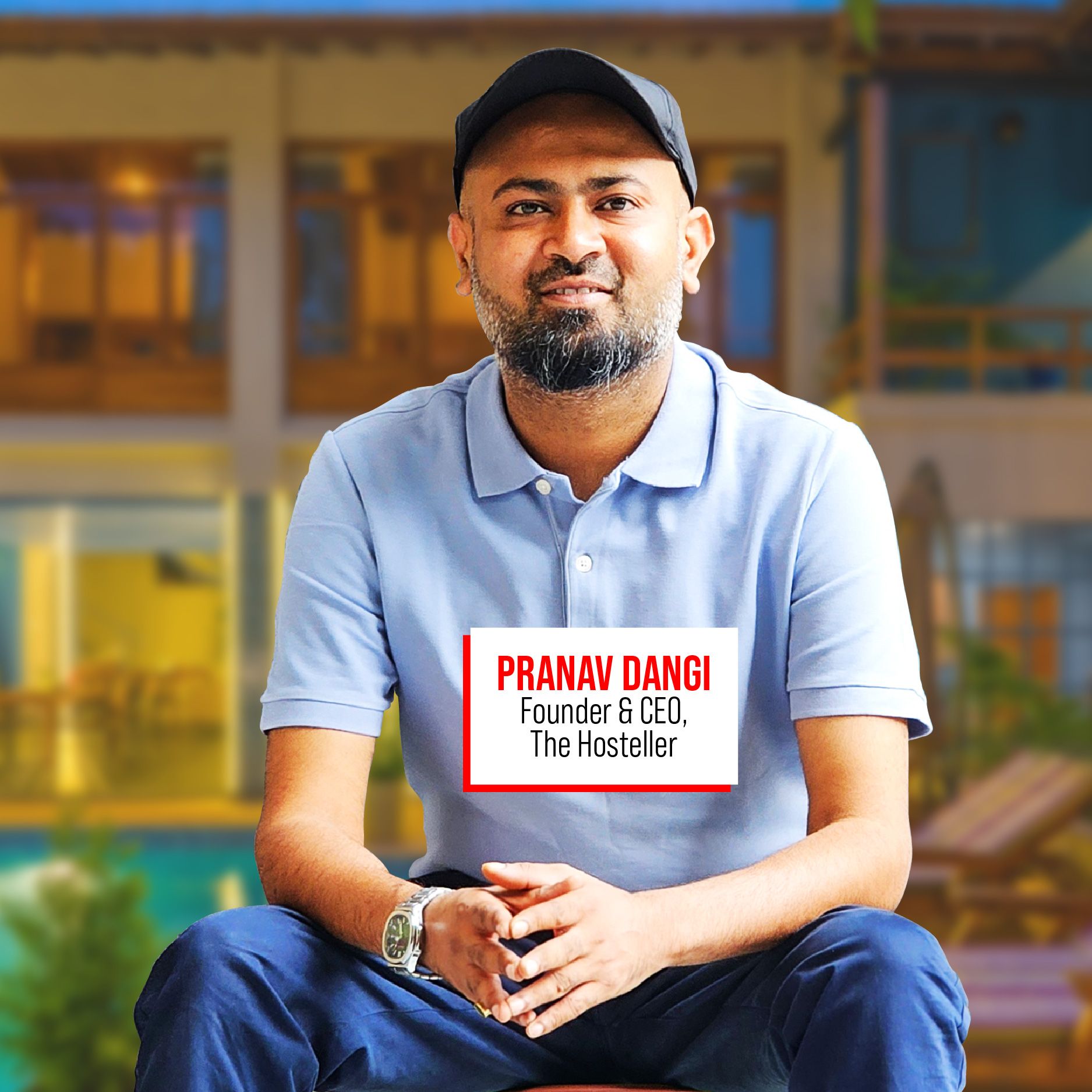 Pranav Dangi seated in a blue polo shirt and cap in a press photograph