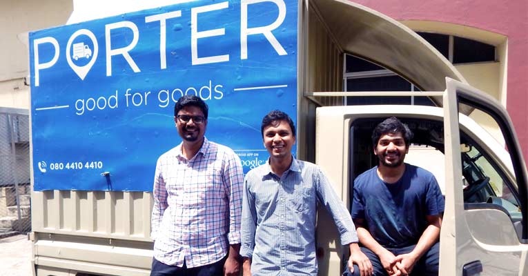 Porter co-founders Uttam Digga, Pranav Goel and Vikas Choudhary beside a branded goods vehicle