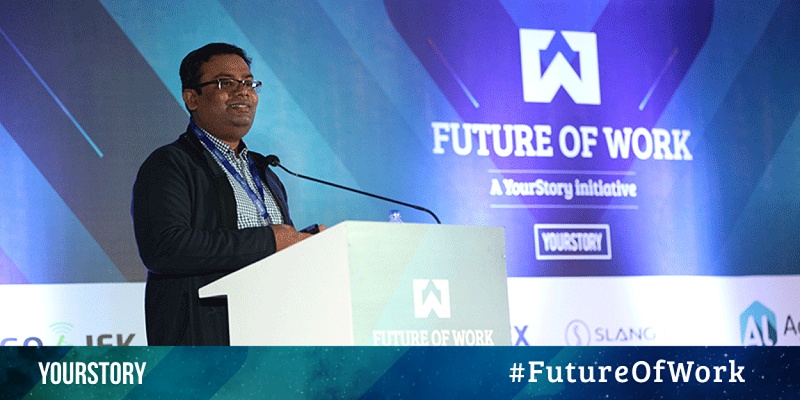 Pravin Jadhav speaking at a lectern at YourStory’s Future of Work conference