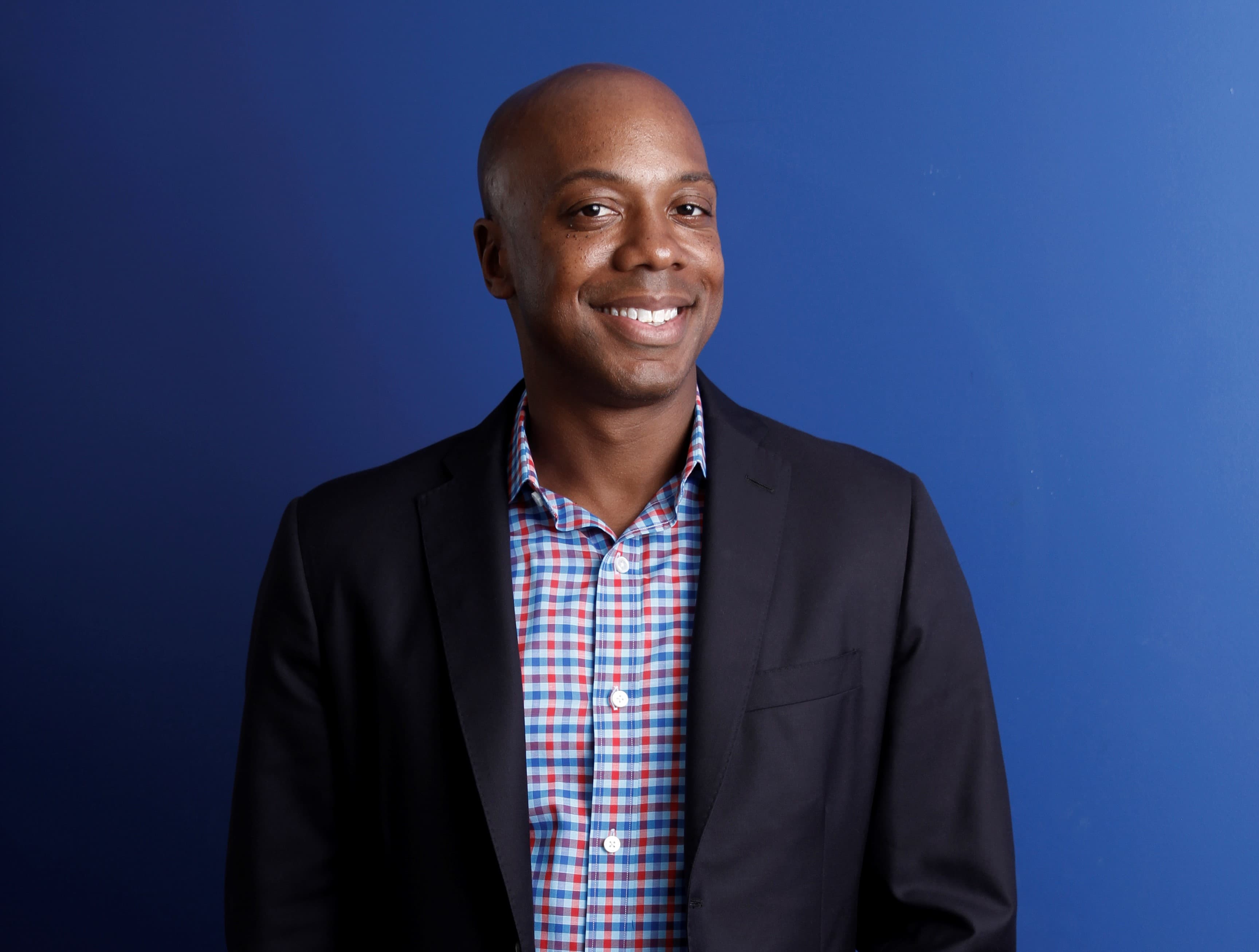 Precursor Ventures founder Charles Hudson in a dark blazer against a blue backdrop