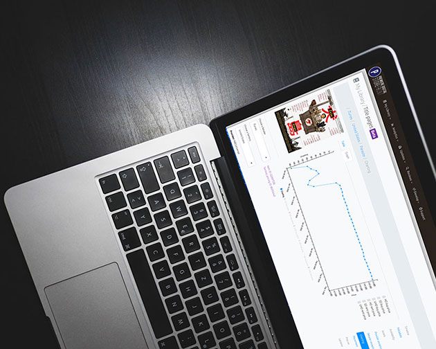 Premiere Digital’s STOREFRONT interface displayed on a laptop with a title detail view and chart