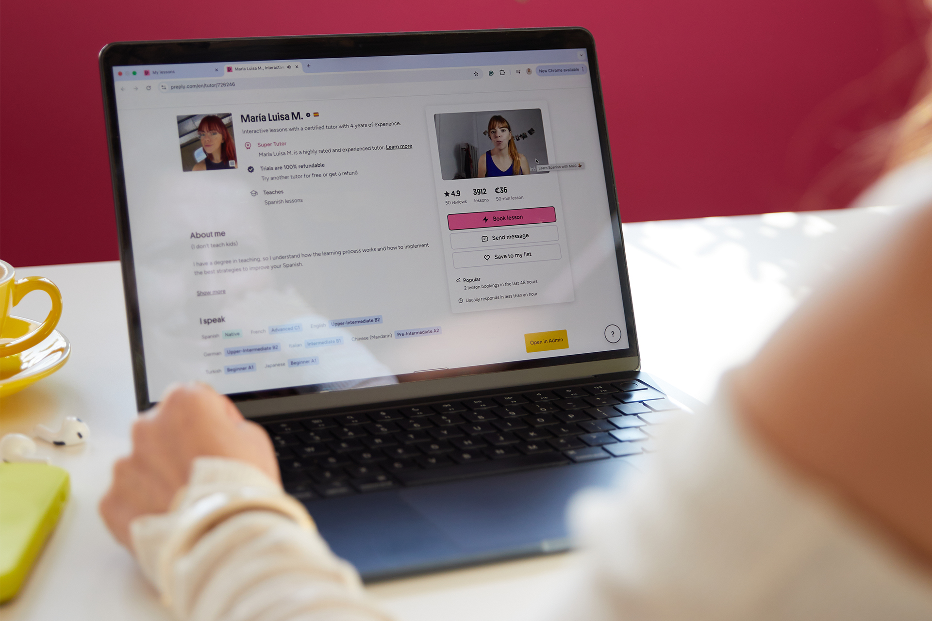 A learner browsing a Spanish tutor’s profile on a laptop