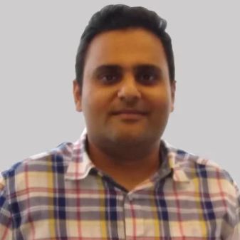 Prerak Parikh in a checked shirt, in a portrait published by The Org