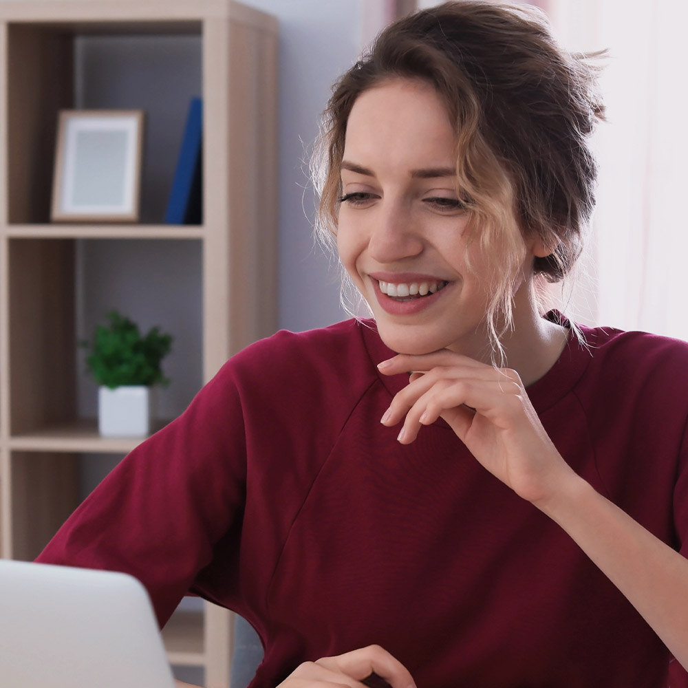 Presence website photograph of a woman working at a laptop
